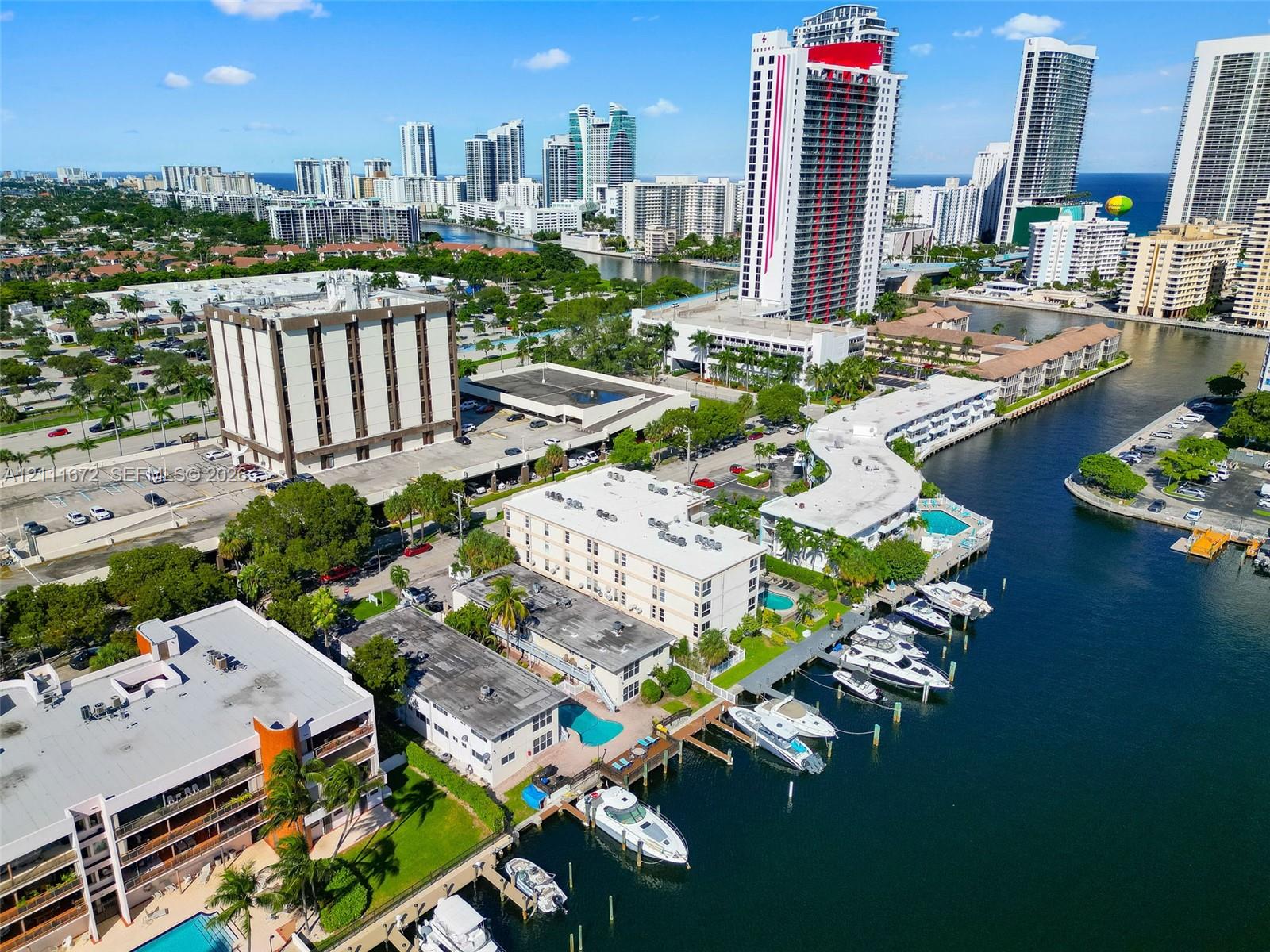 Waterfront property featuring private boat slips, deep-water canal access, multiple swimming pools, and manicured landscaping