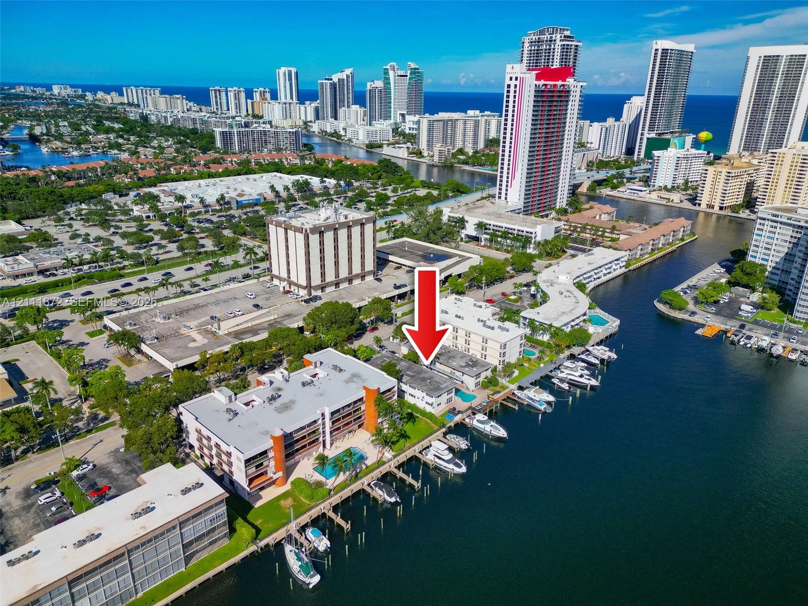 Waterfront residential building featuring direct canal access, deep-water dockage, and an outdoor swimming pool