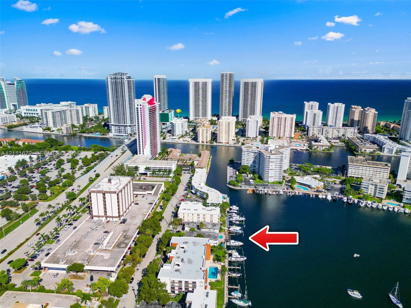 Aerial perspective of a waterfront property featuring direct dockage, deep-water access, and a community swimming pool