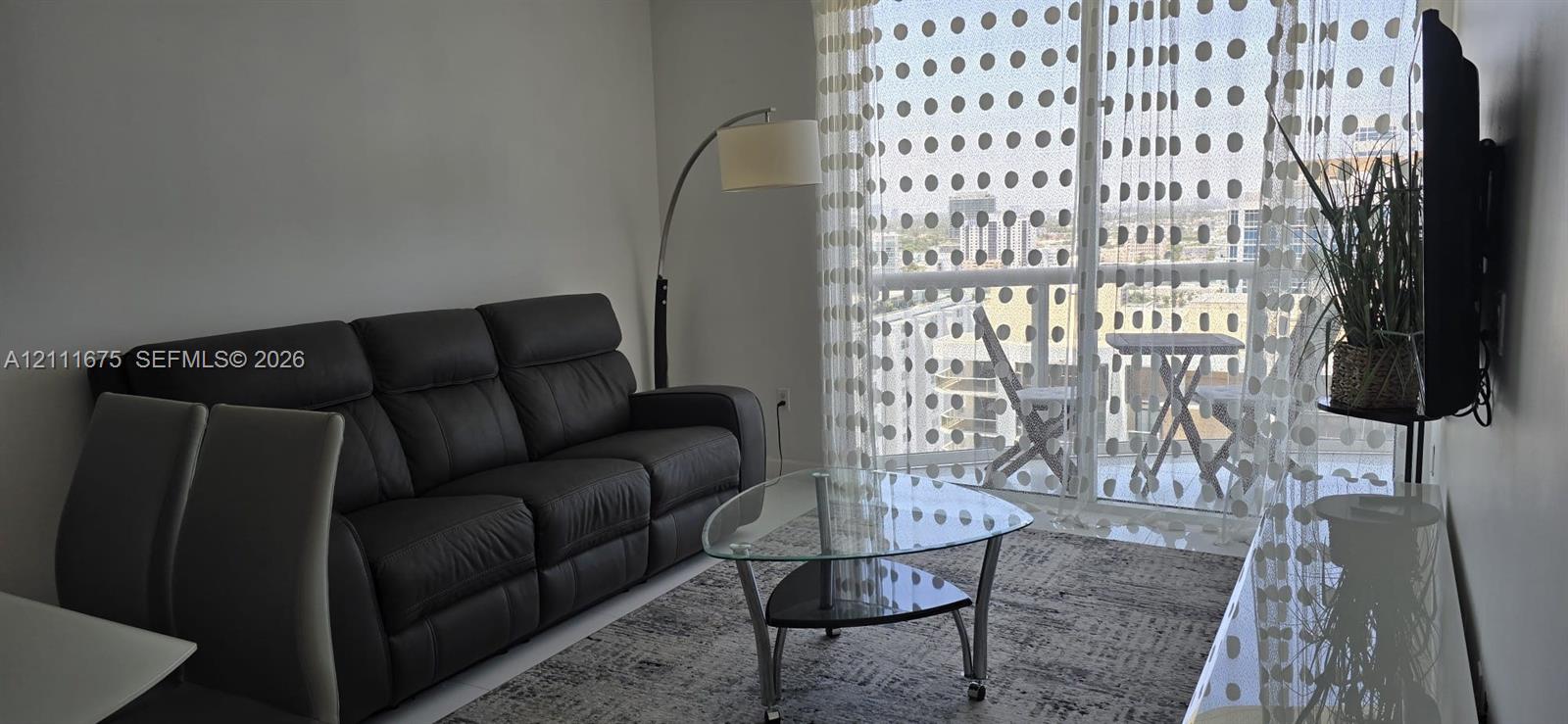 Full-height glass sliding door with access to a private balcony
