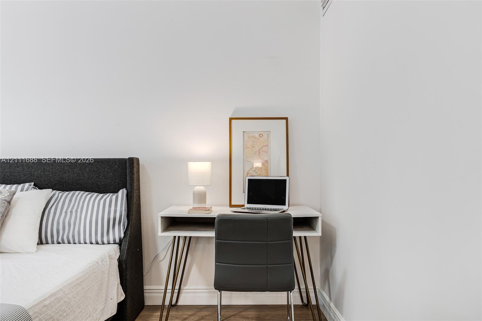 Neutral interior featuring white walls and wood-finish flooring
