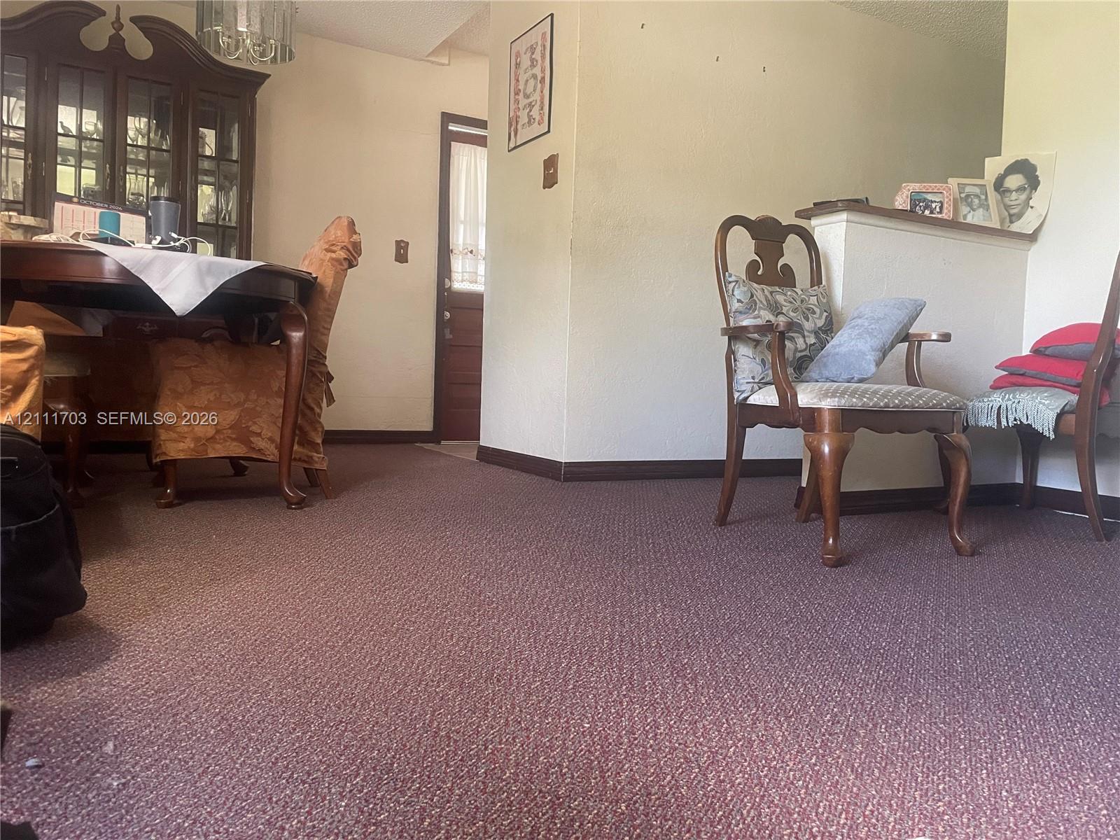Interior space featuring wall-to-wall carpeting and a half-height partition wall with a flat surface ledge Interior space featuring wall-to-wall carpeting and a half-height partition wall with a flat surface ledge