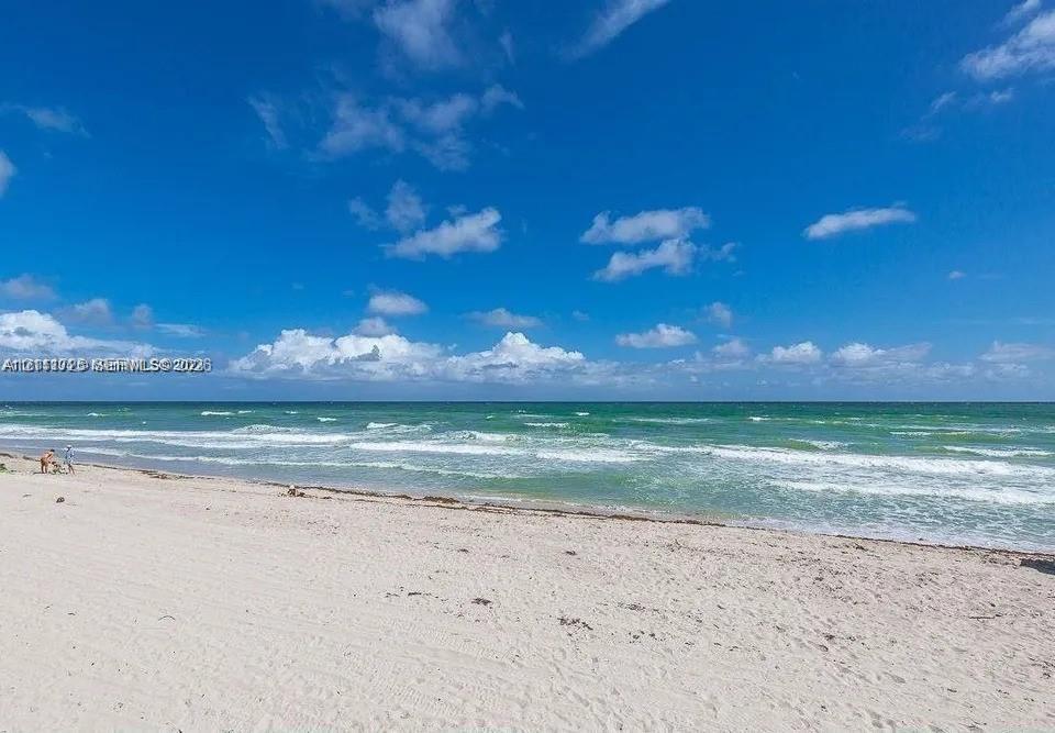 Sandy shoreline bordering the Atlantic Ocean with clear horizon