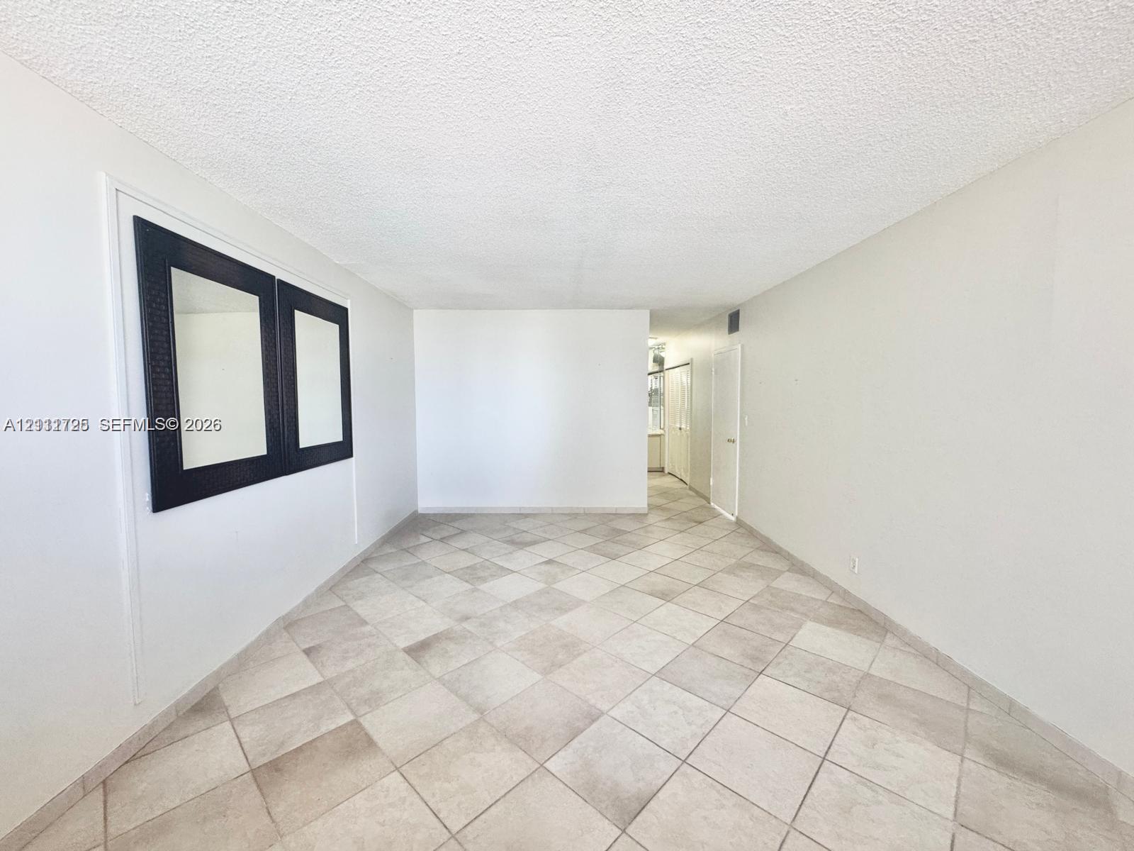 Interior space featuring large-format ceramic tile flooring and neutral wall finishes