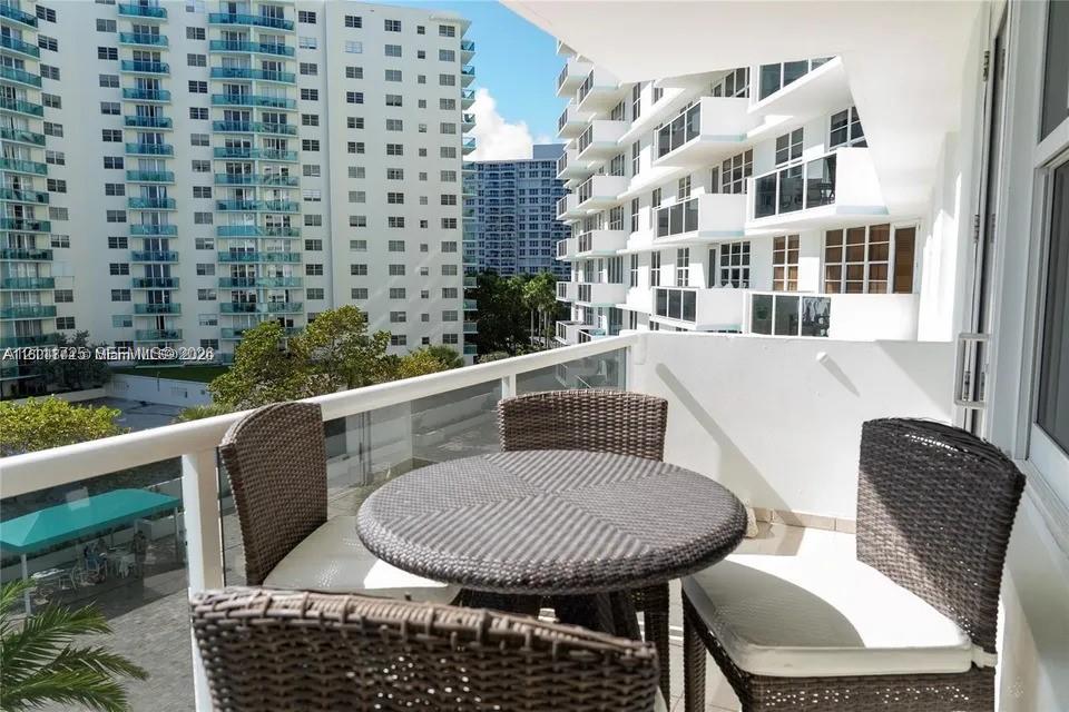 Private balcony featuring a glass-panel railing and tile flooring