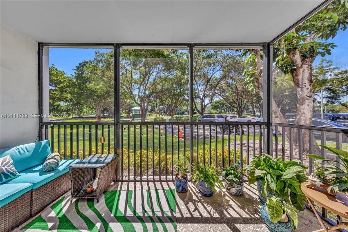 Screened-in porch featuring metal framing, solid ceiling, and concrete flooring