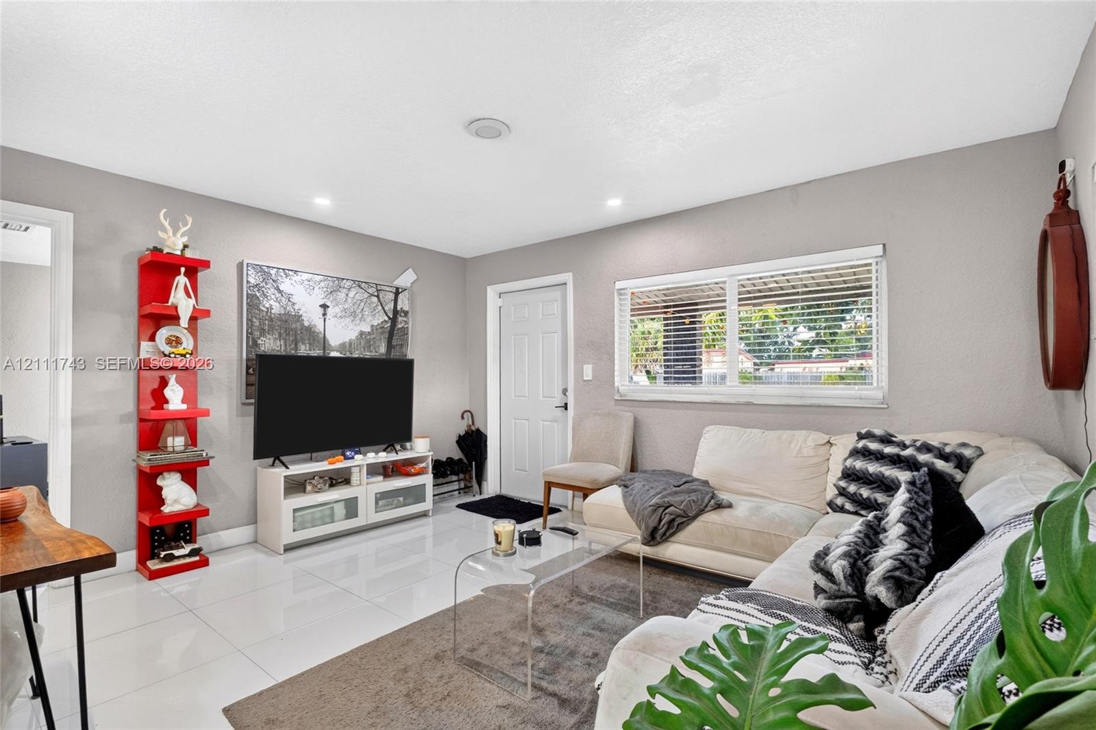 Polished tile flooring, recessed ceiling lighting, and horizontal window blinds