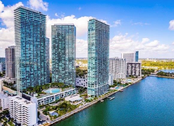 High-rise towers featuring glass-paneled balconies, floor-to-ceiling windows, and a waterfront location with an outdoor swimming pool High-rise towers featuring glass-paneled balconies, floor-to-ceiling windows, and a waterfront location with an outdoor swimming pool