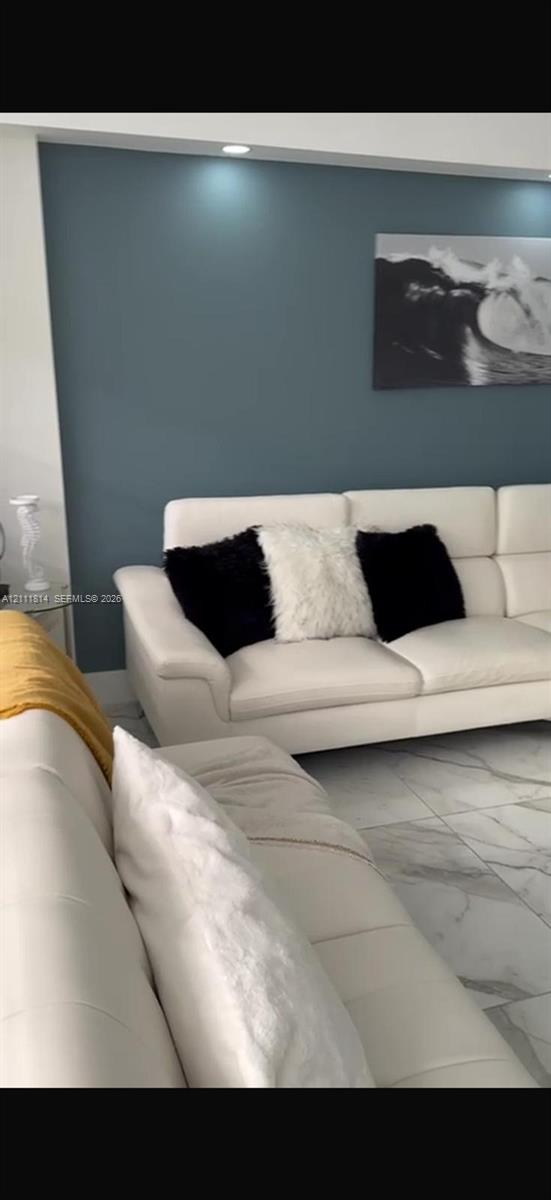 Large-format tile flooring, accent wall, and recessed ceiling lighting Large-format tile flooring, accent wall, and recessed ceiling lighting