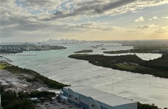 Panoramic bay and coastal skyline scenery featuring expansive water frontage, mangrove-lined shorelines, and distant urban horizon Panoramic bay and coastal skyline scenery featuring expansive water frontage, mangrove-lined shorelines, and distant urban horizon