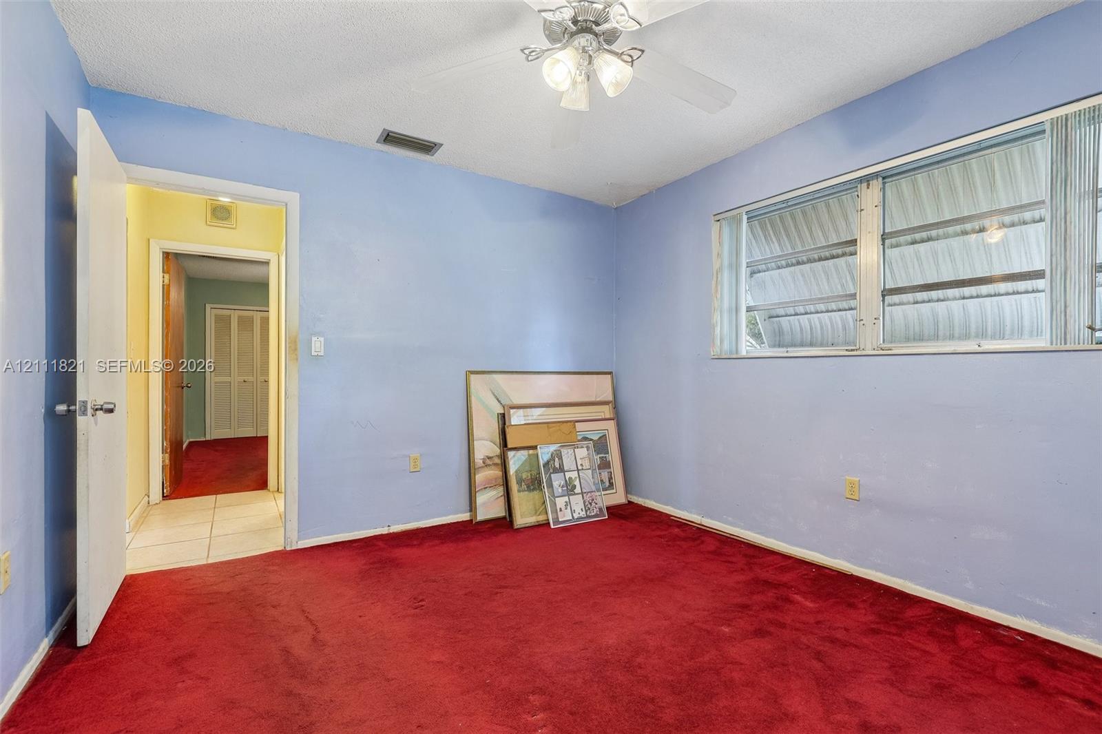 Interior space featuring wall-to-wall carpeting, a ceiling fan with integrated lighting, and horizontal sliding windows