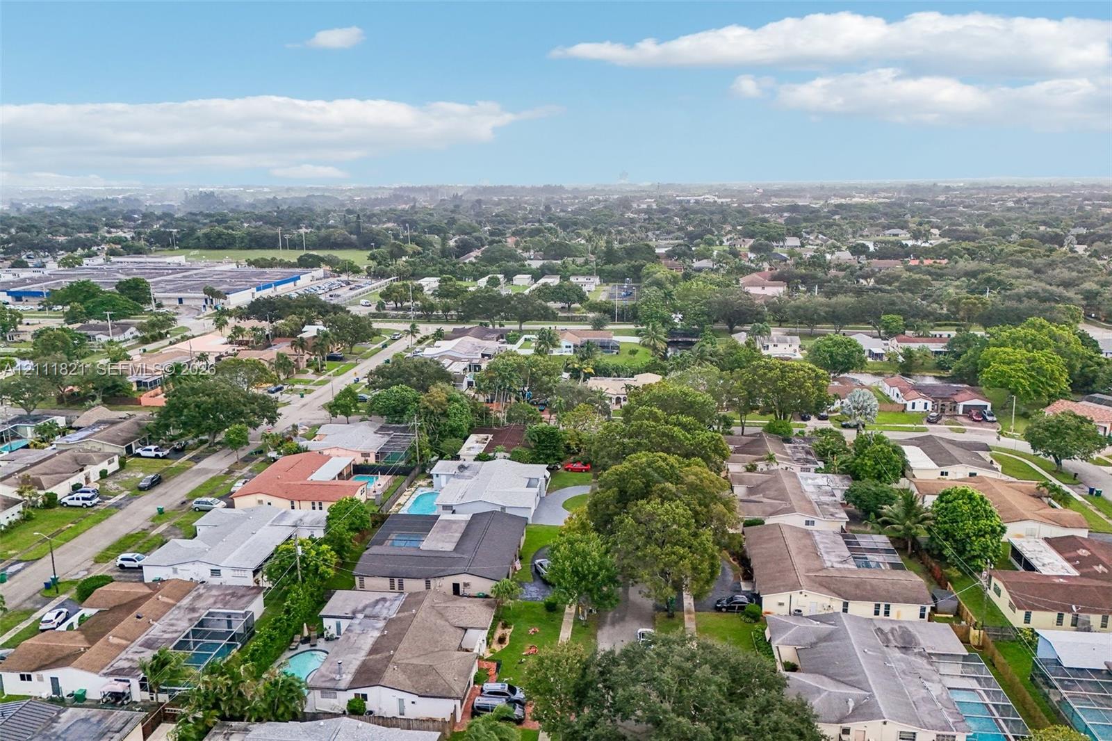 Aerial perspective of the residential parcel featuring dense mature canopy trees and a private swimming pool