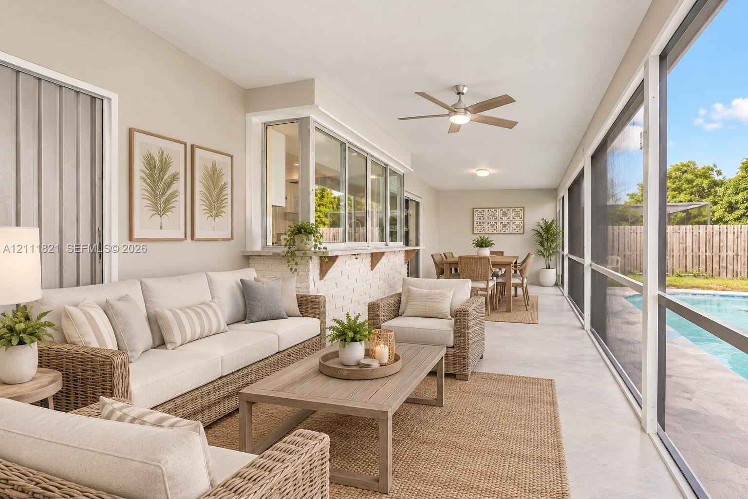 virtually staged screened-in patio featuring a service window direct access to an in-ground swimming pool