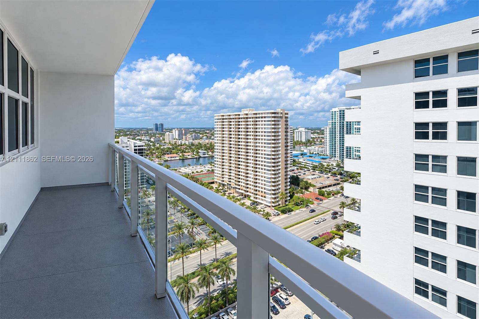 Covered balcony with a solid-surface floor and perimeter glass-panel railing