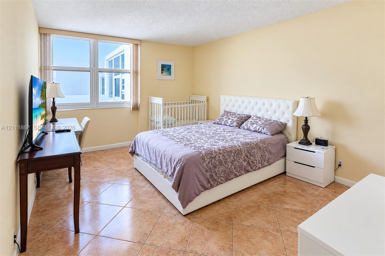 Spacious room featuring large-format diagonal tile flooring and expansive windows with natural light
