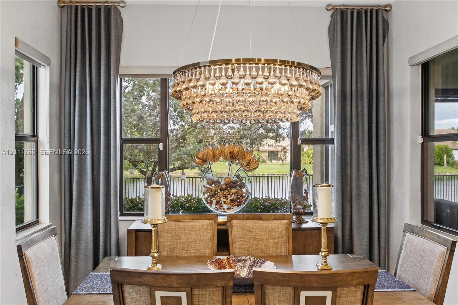 Comfortable Dining Area - with lots of natural light, a crystal chandelier and lake view.