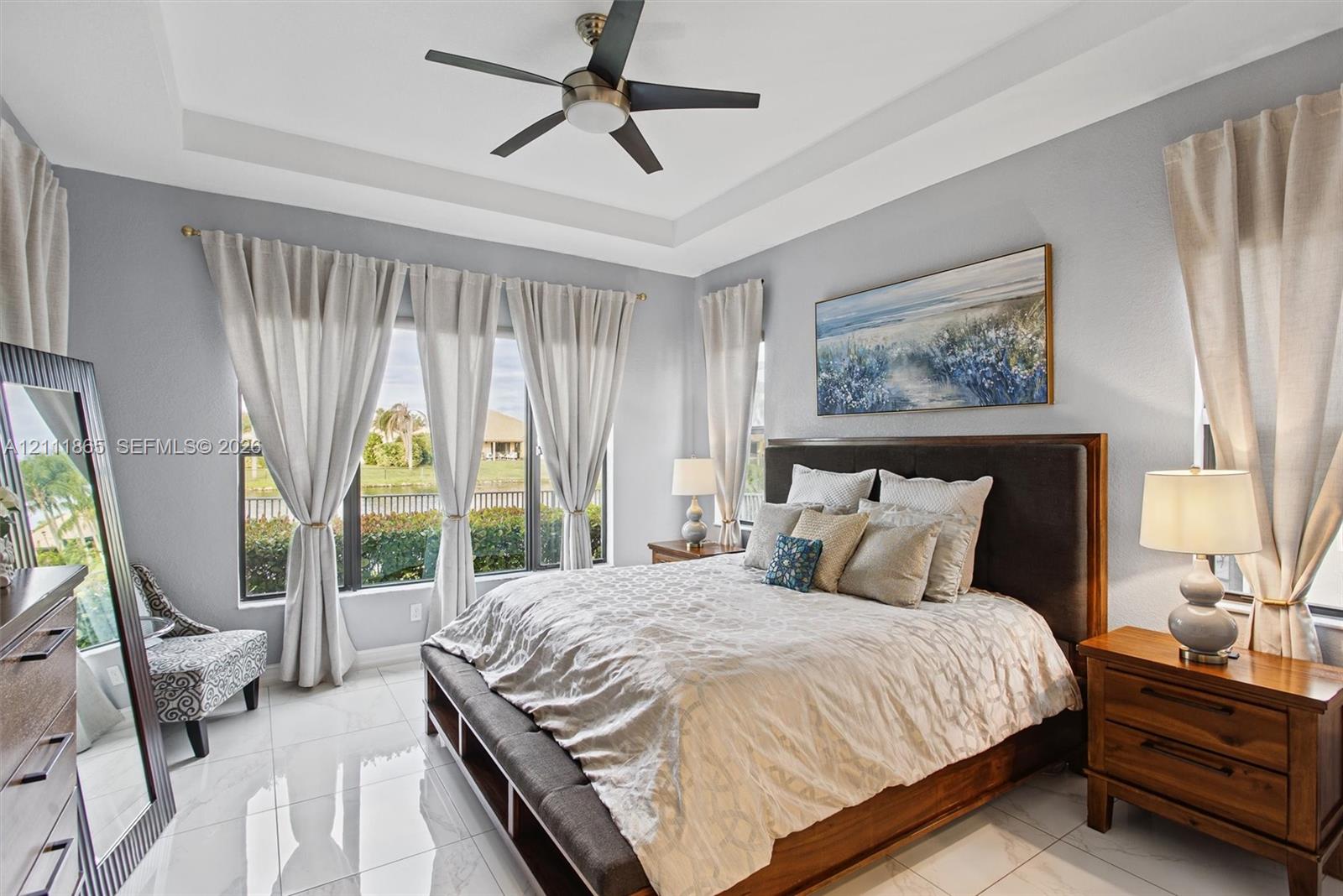 Large Master with tray ceiling, lighted ceiling fan & expansive windows.