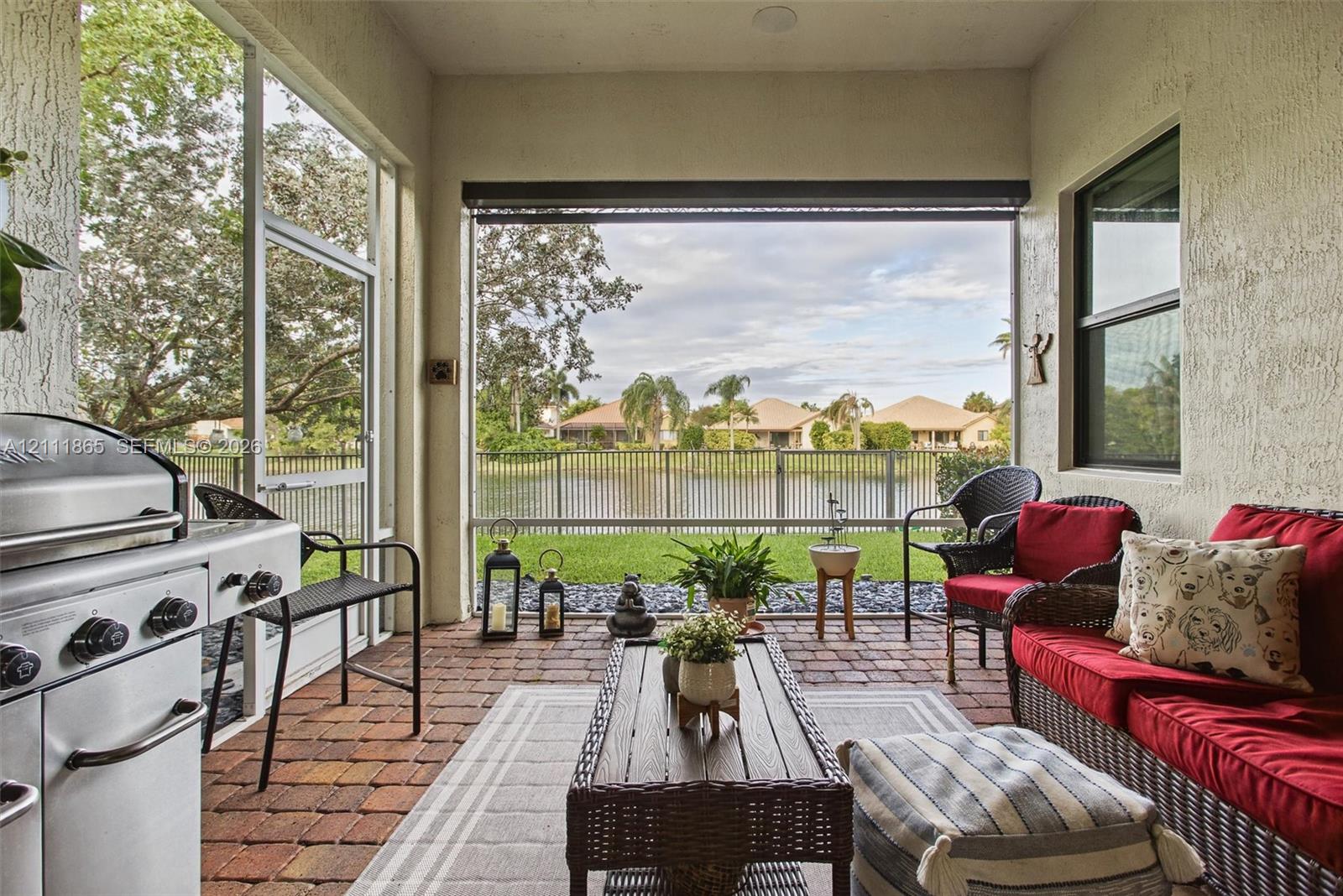 Cozy screened-in lanai with additional sunscreen & great water view.