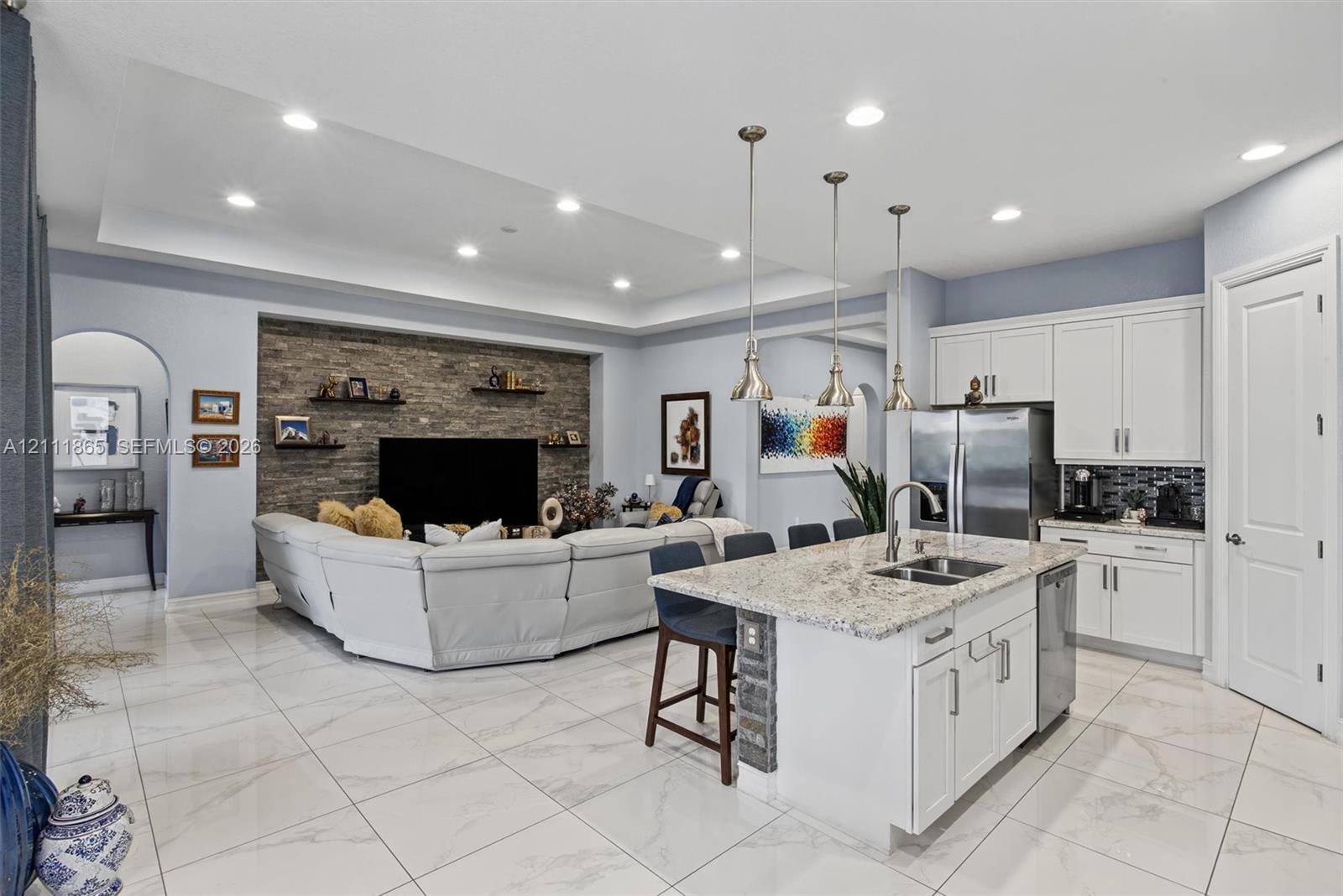 Broad open concept view - notice high vaulted ceilings, sunken lights and elegant 24 x 24 tiles.