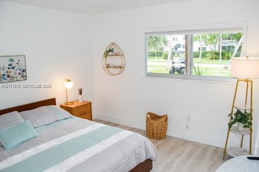 Neutral-toned interior featuring wood-finish flooring and a wide, horizontal sliding window