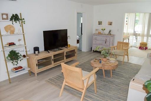 Light-toned wood-finish flooring, smooth wall surfaces, and sliding glass panel doors Light-toned wood-finish flooring, smooth wall surfaces, and sliding glass panel doors