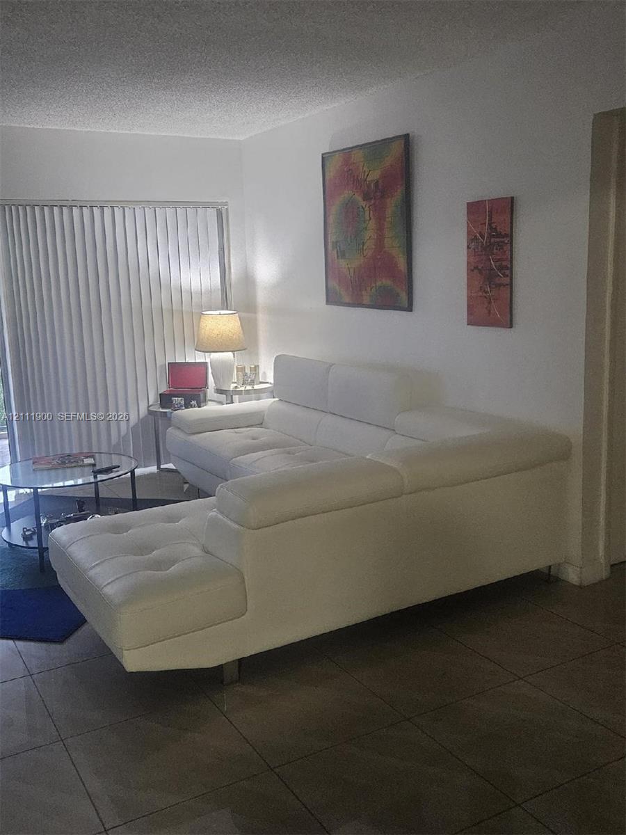 Neutral tile flooring and vertical blind window treatments