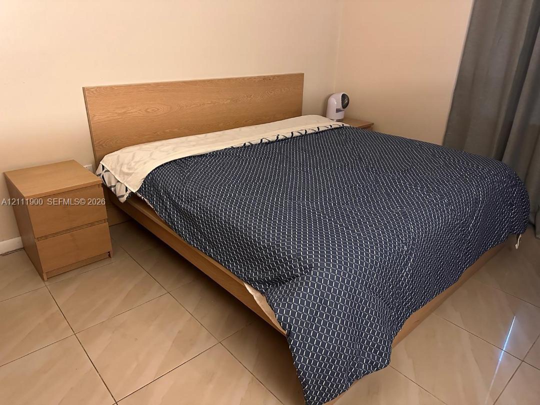 Room featuring neutral wall tones and large-format tile flooring