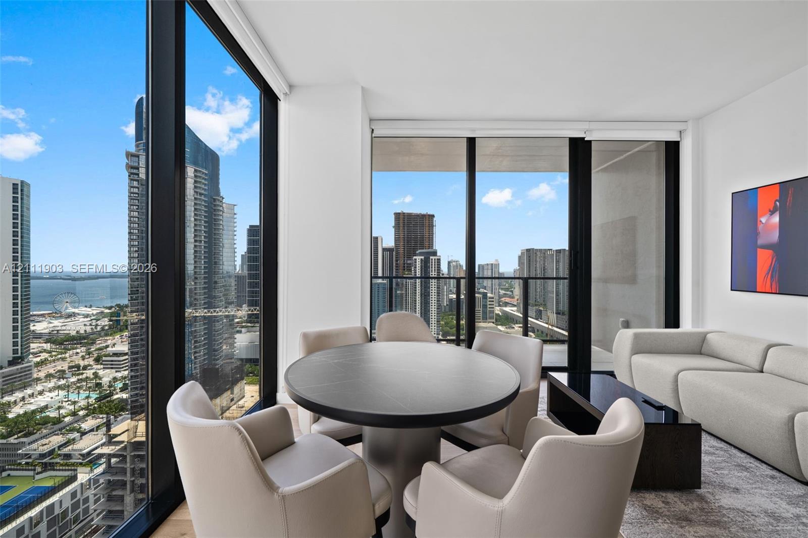 Floor-to-ceiling windows, wrap-around glazing, urban skyline scenery, and integrated balcony access