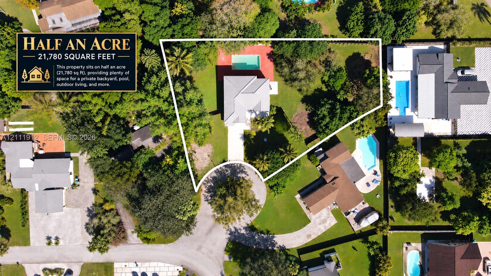 Half-acre lot featuring a swimming pool, expansive grounds, mature trees, and a concrete driveway