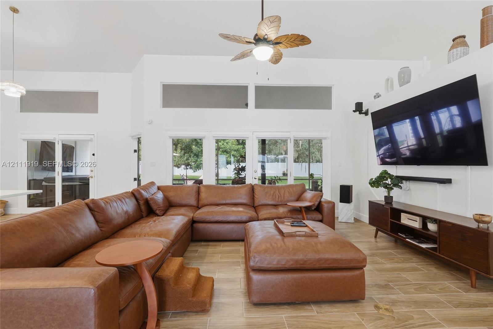 Vaulted ceilings featuring clerestory windows, tile flooring, and a ceiling fan Vaulted ceilings featuring clerestory windows, tile flooring, and a ceiling fan