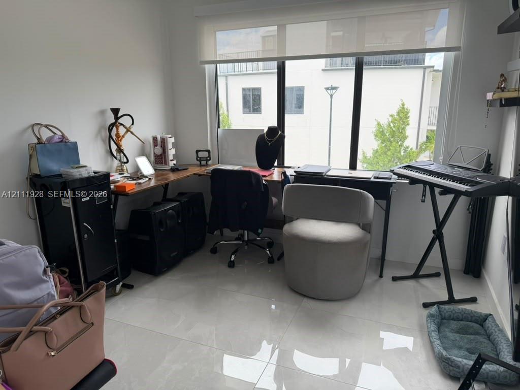 Large-format floor tile, expansive floor-to-ceiling window, and installed roller shade