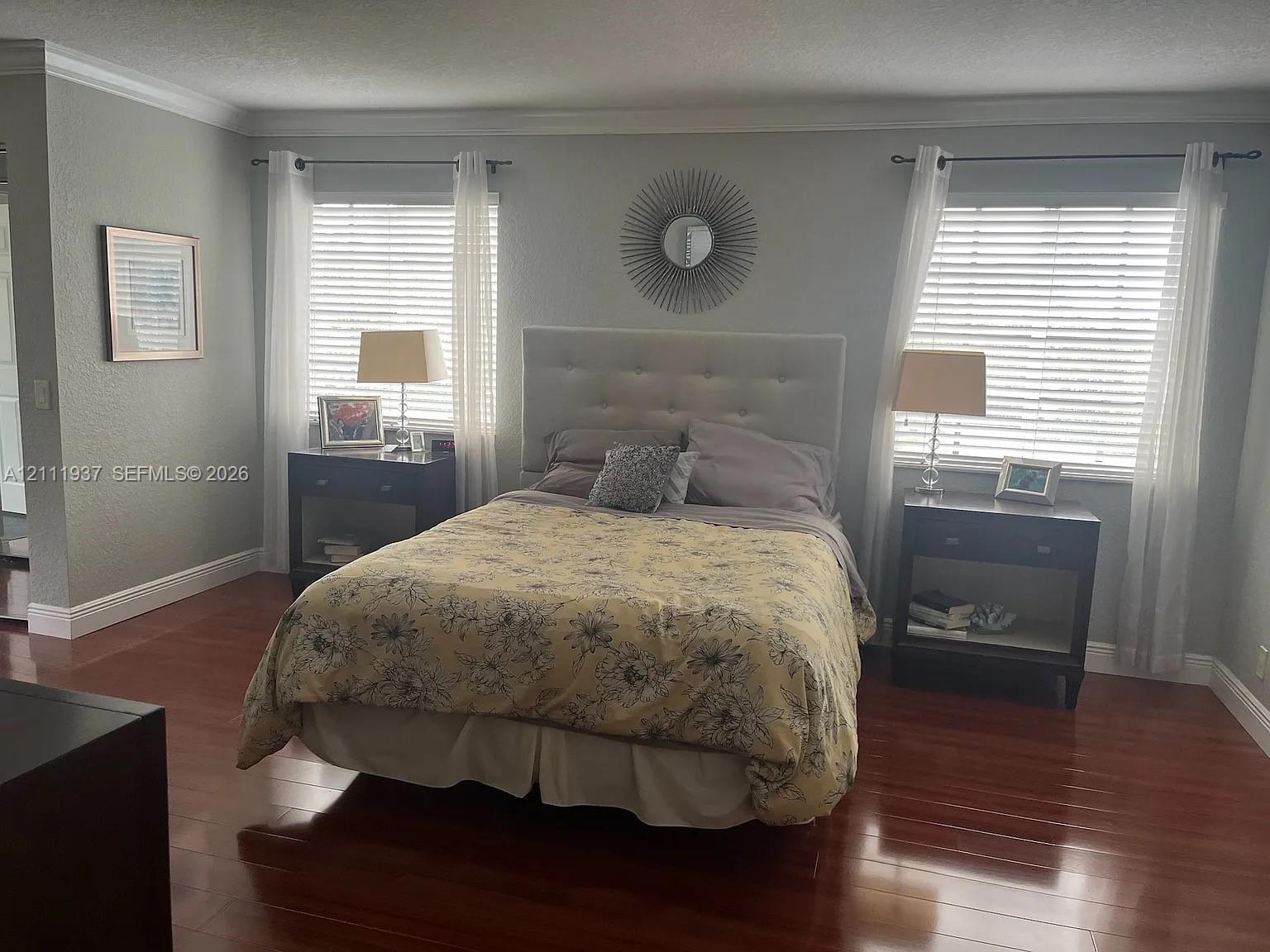 Wood-finish flooring, dual windows with blinds, and crown molding