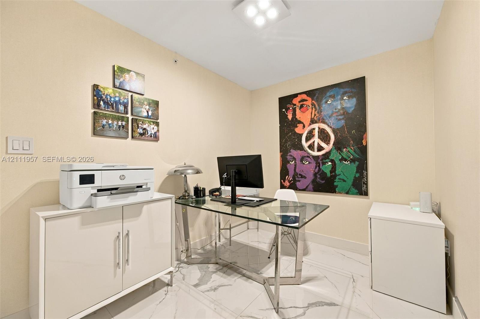 Interior room featuring high-gloss white built-in cabinetry, polished stone-finish flooring with grey veining, and a flush-mount square LED light fixture