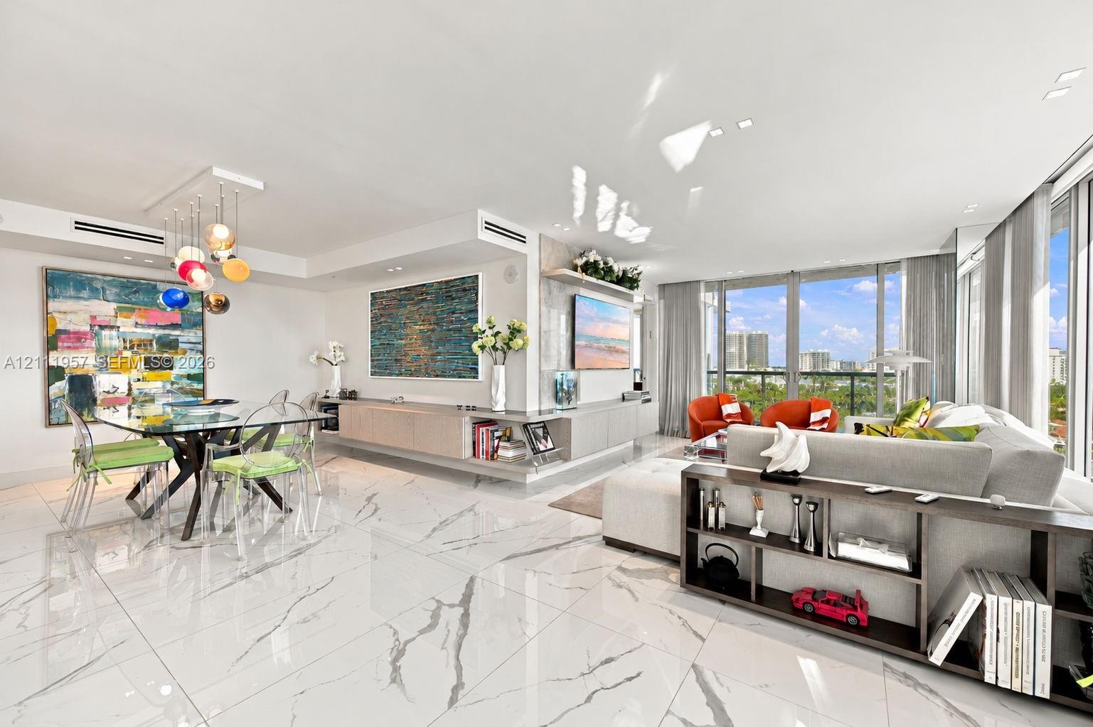 Open-concept living space featuring large-format veined tile flooring, built-in recessed cabinetry, floor-to-ceiling windows, and recessed lighting Open-concept living space featuring large-format veined tile flooring, built-in recessed cabinetry, floor-to-ceiling windows, and recessed lighting