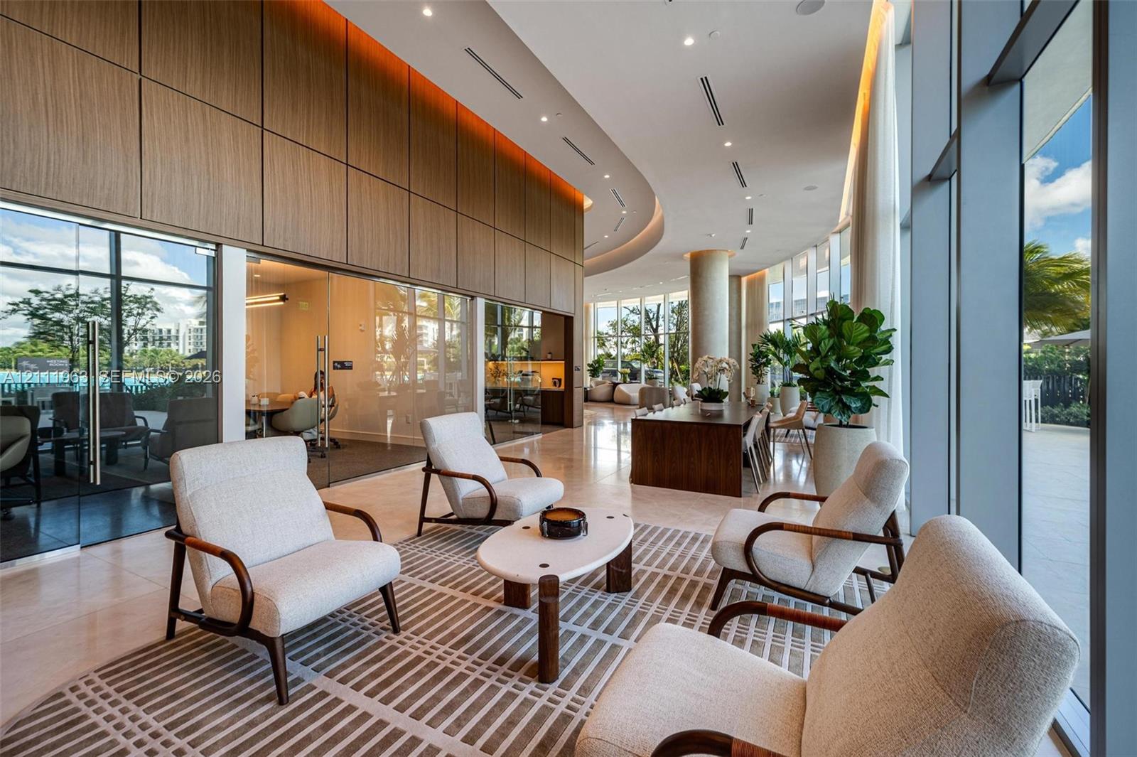 Expansive room featuring a wood-paneled ceiling with recessed cove lighting, floor-to-ceiling windows, wood-finish flooring, and a large island topped with a stone-finish countertop
