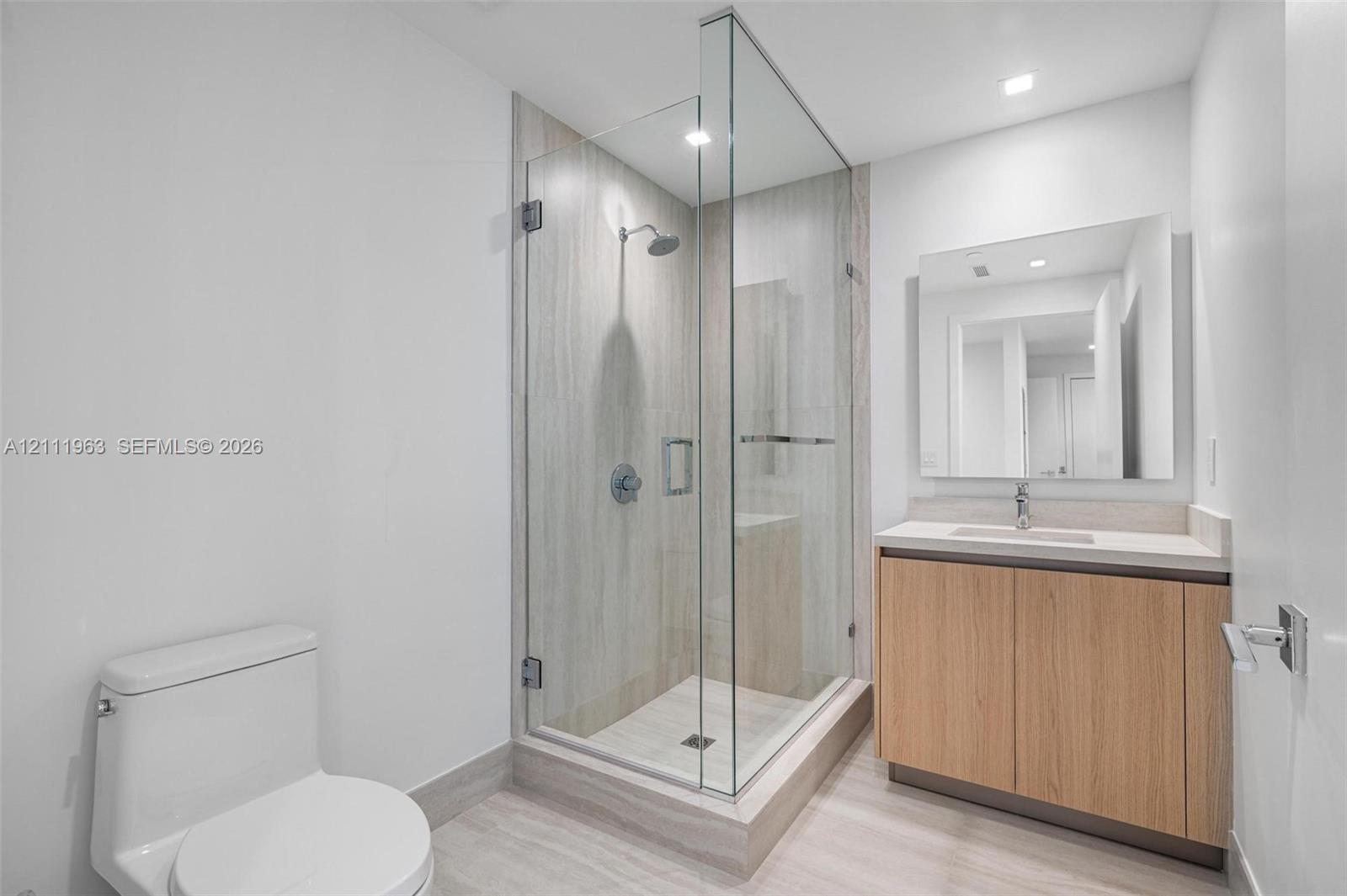 Floor-to-ceiling sliding glass doors, tiled balcony, neutral interior finish, and ceramic tile flooring