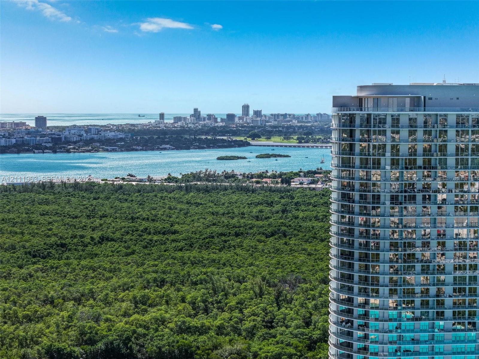 High-rise residential structure featuring floor-to-ceiling glass windows and expansive private balconies