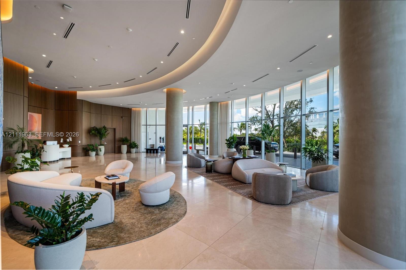 Floor-to-ceiling windows, polished stone flooring, recessed ceiling lighting, and built-in wood shelving