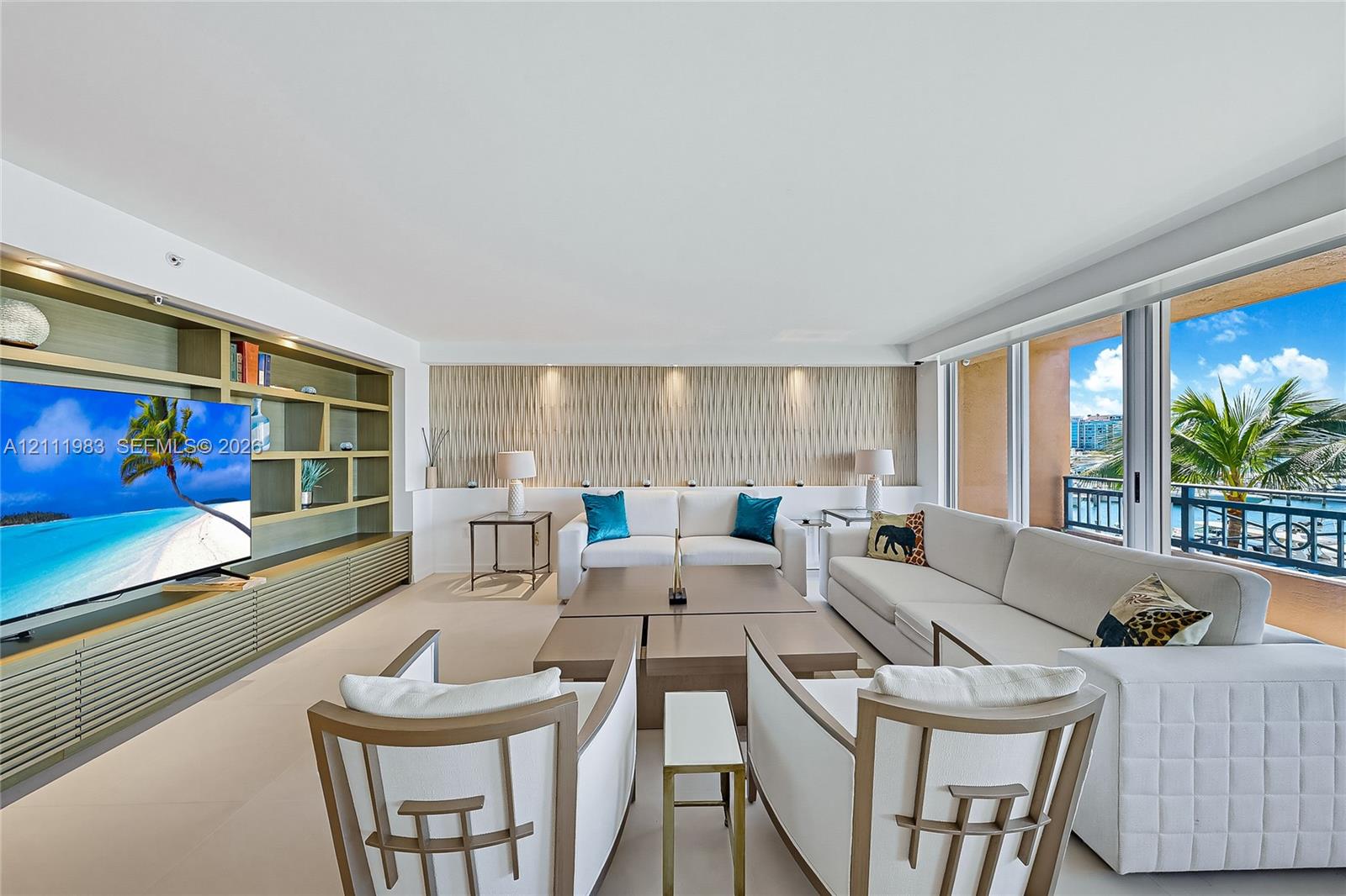 Living area featuring floor-to-ceiling glass sliding doors, built-in floor-to-ceiling shelving, recessed lighting, and textured accent wall paneling