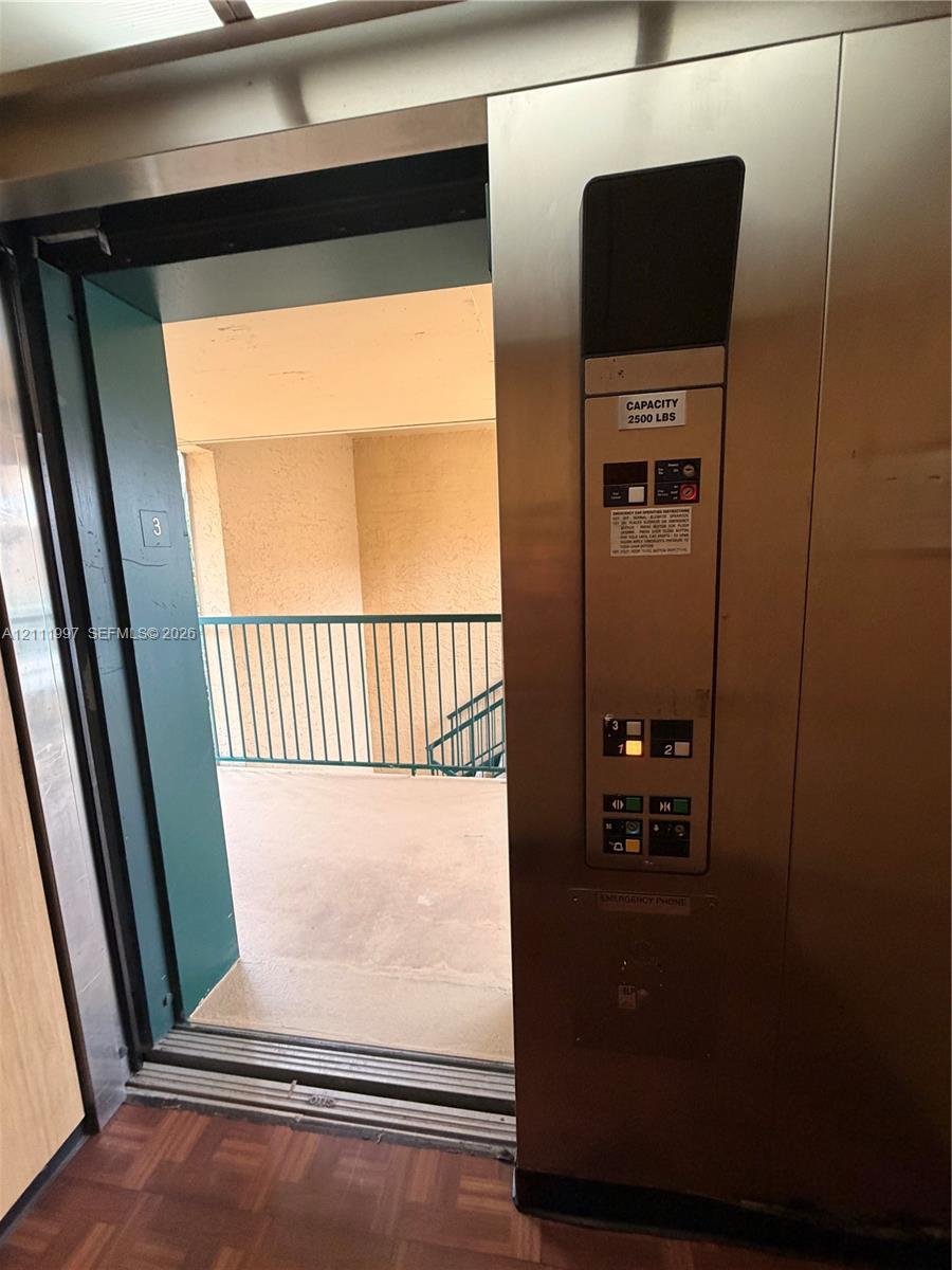 Elevator featuring a stainless steel control panel, 2500-pound weight capacity, and parquet flooring