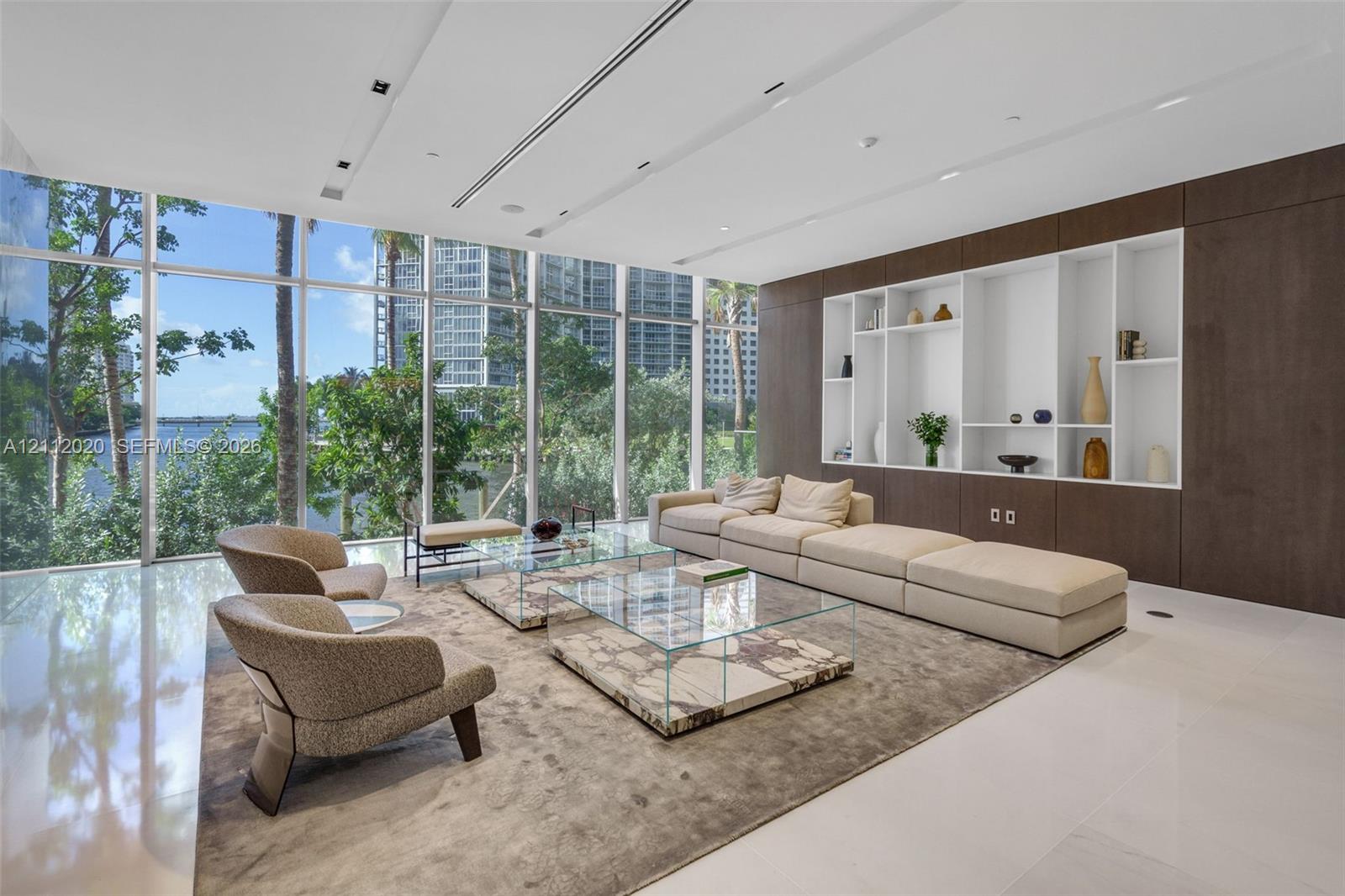 Floor-to-ceiling glass windows, built-in floor-to-ceiling cabinetry with integrated display shelving, large-format tile flooring, and recessed ceiling lighting