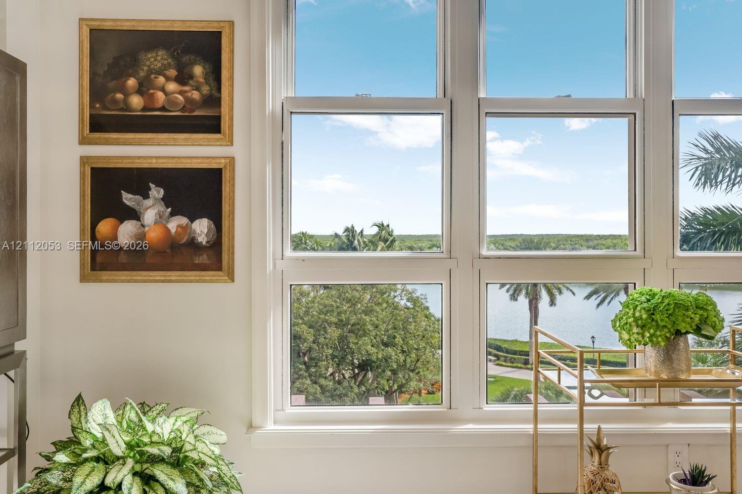 Multi-pane white-trimmed windows offering expansive water and landscape scenery Multi-pane white-trimmed windows offering expansive water and landscape scenery