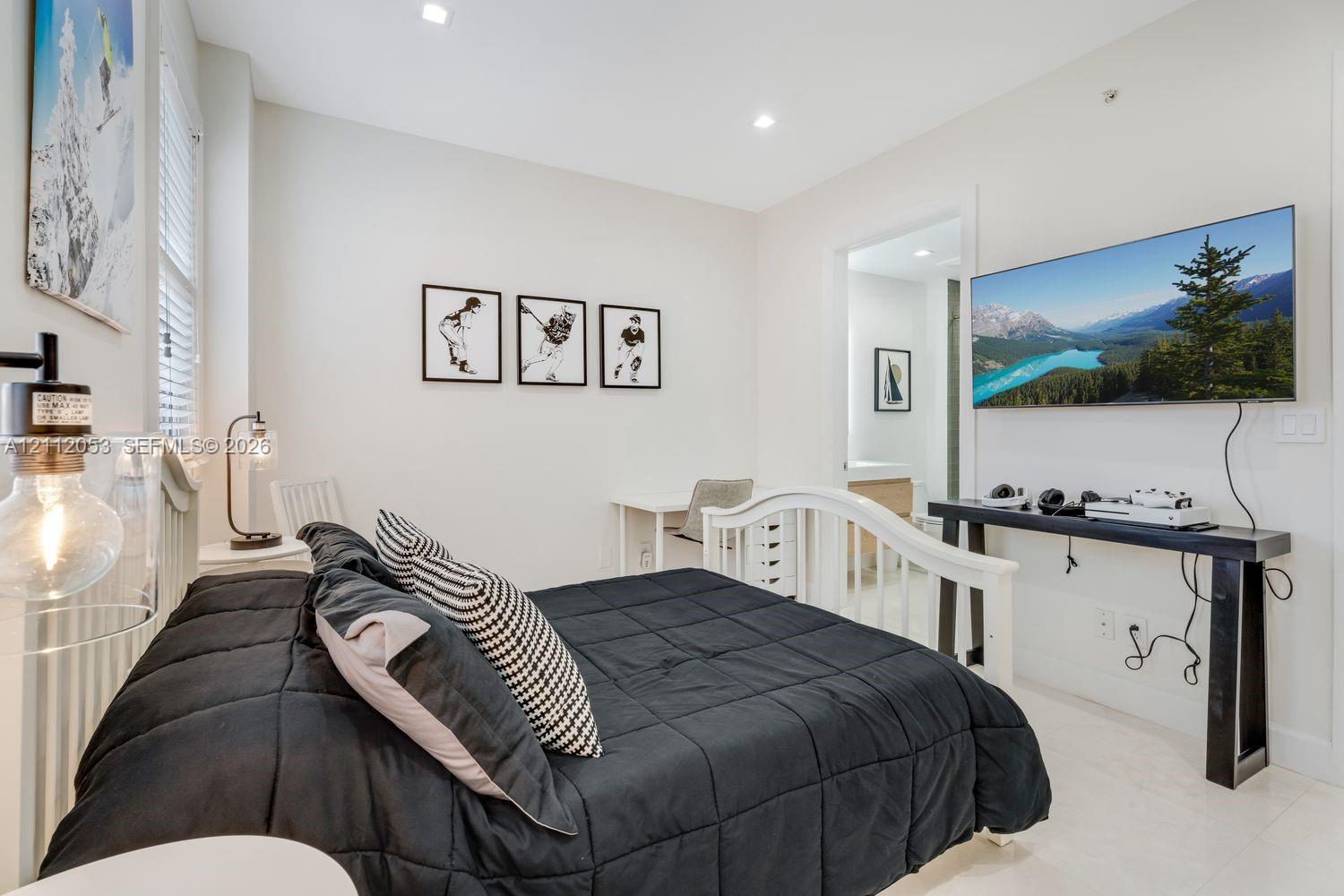 Neutral-toned interior featuring recessed ceiling lighting, light-toned flooring, and window blinds