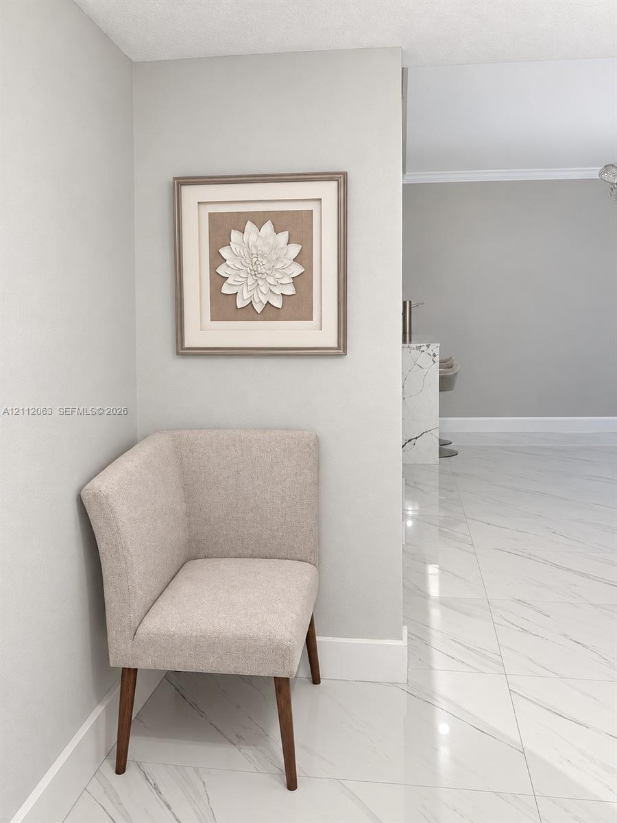 Large-format polished stone flooring with neutral veining throughout Large-format polished stone flooring with neutral veining throughout