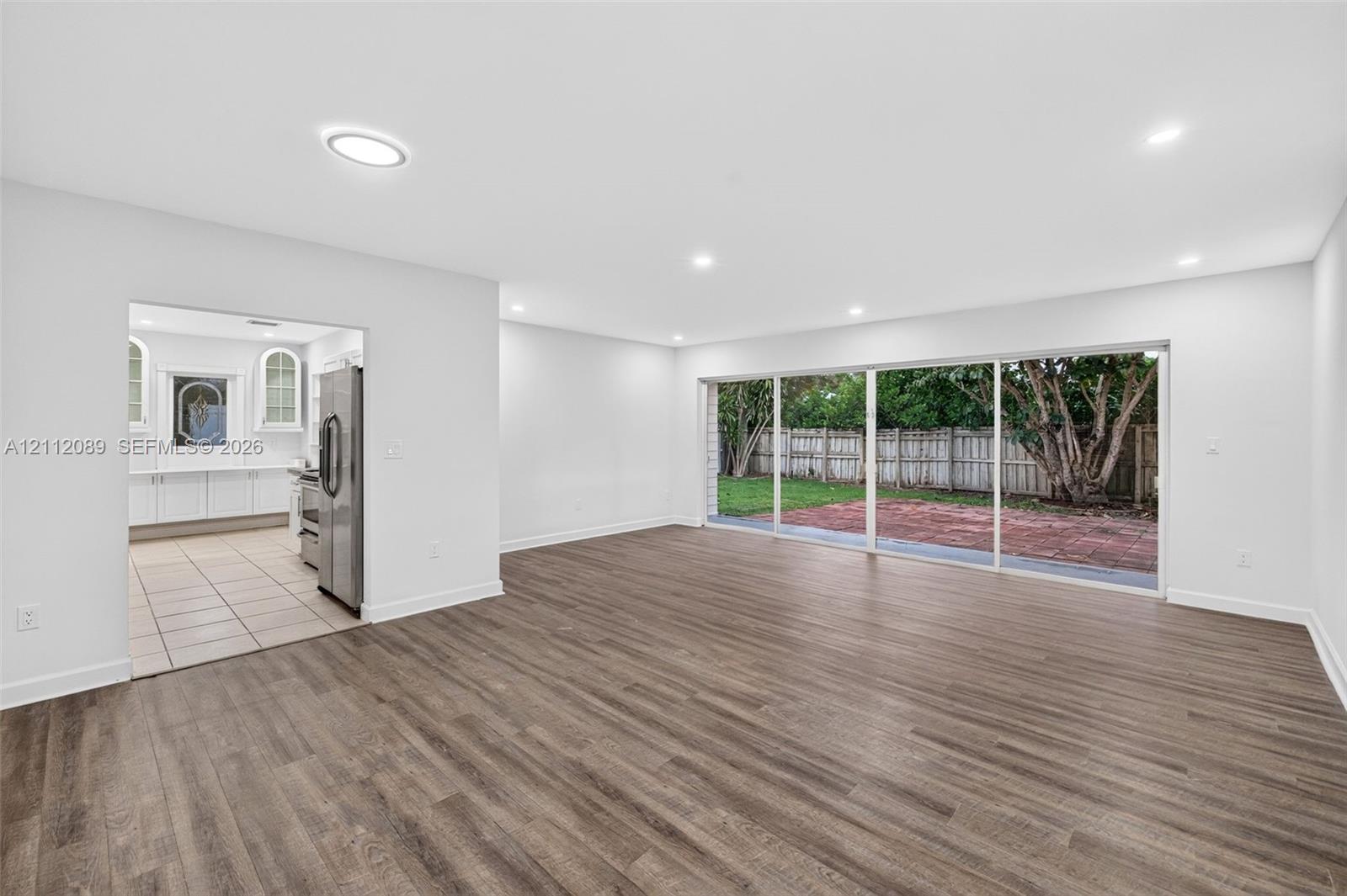 Interior space featuring wood-finish flooring, recessed lighting, and large sliding glass doors