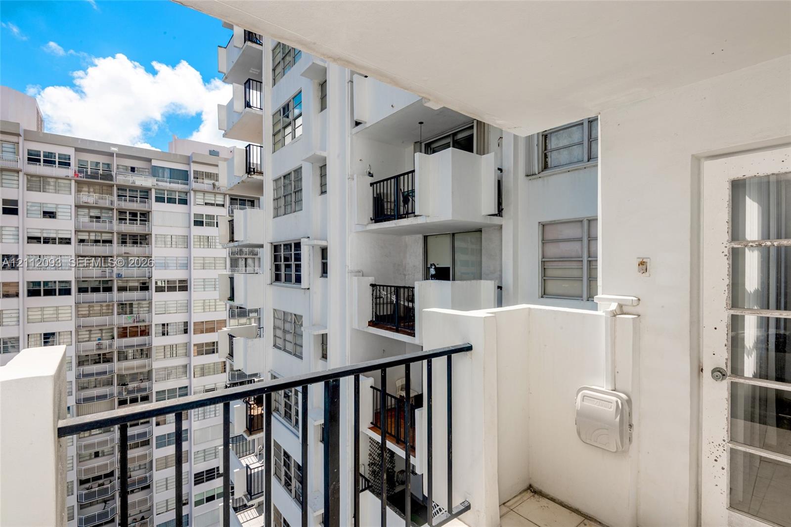Private balcony featuring tile flooring and a metal railing