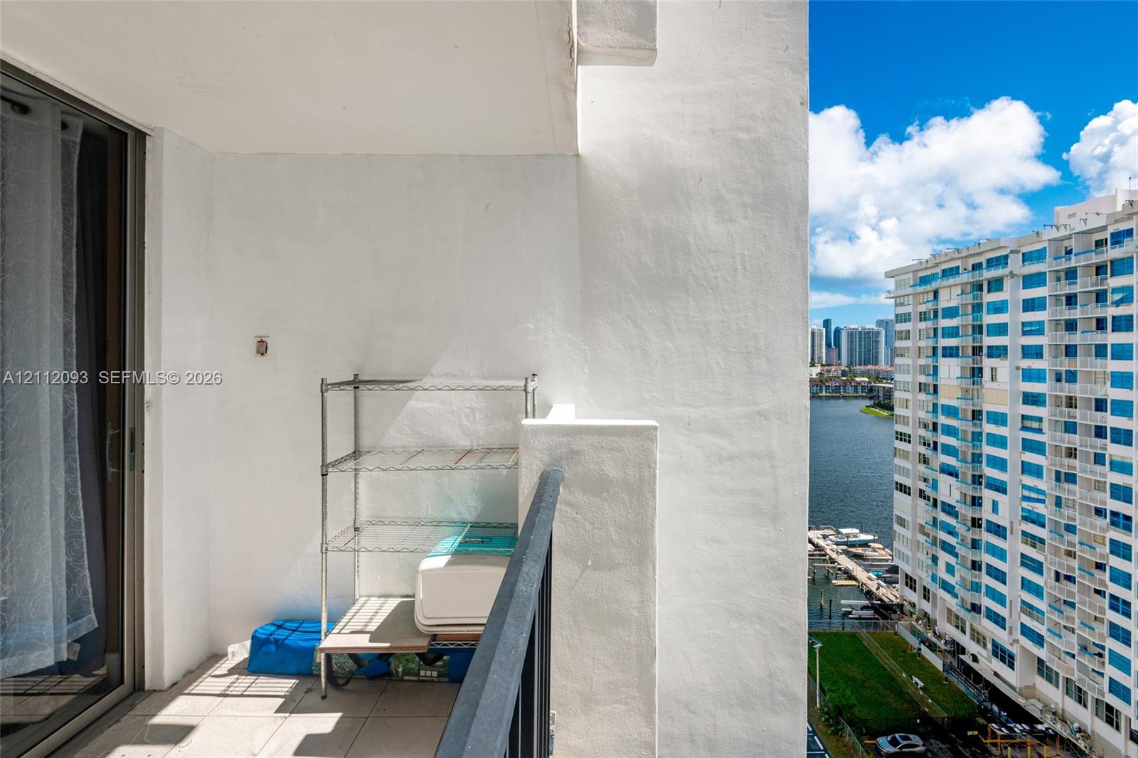 Covered balcony with a concrete floor and a metal railing