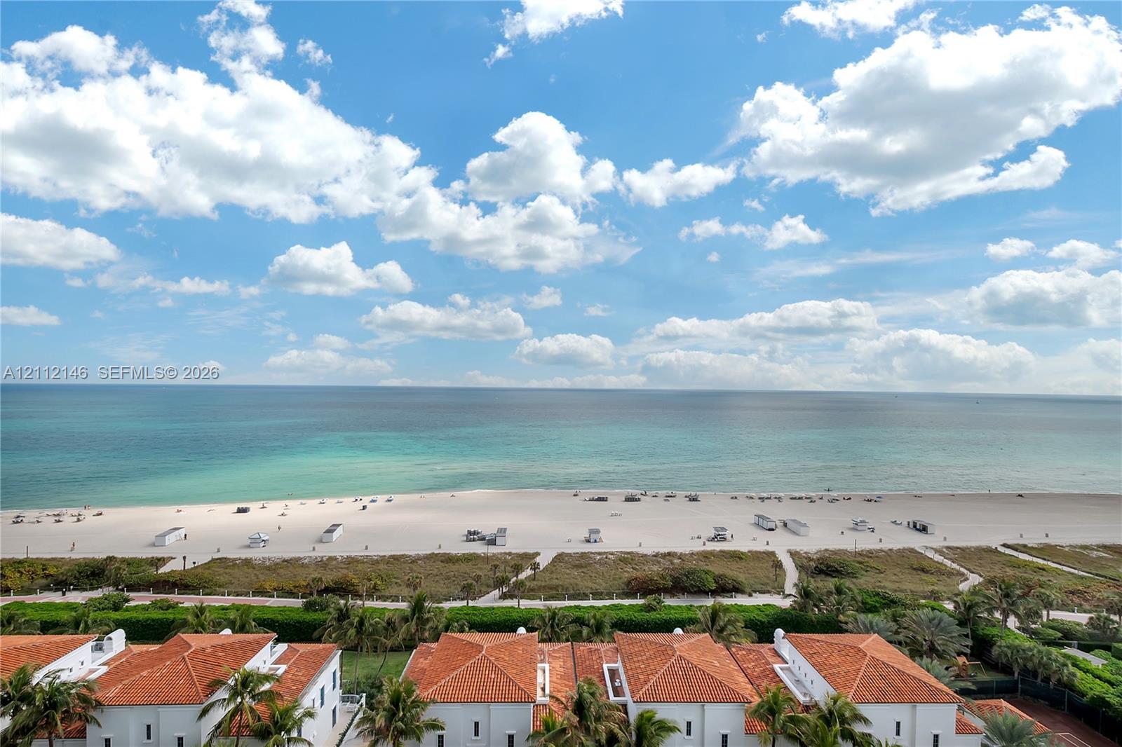 Exterior perspective showcasing terracotta-tiled roofs, sandy shoreline, and expansive ocean scenery Exterior perspective showcasing terracotta-tiled roofs, sandy shoreline, and expansive ocean scenery