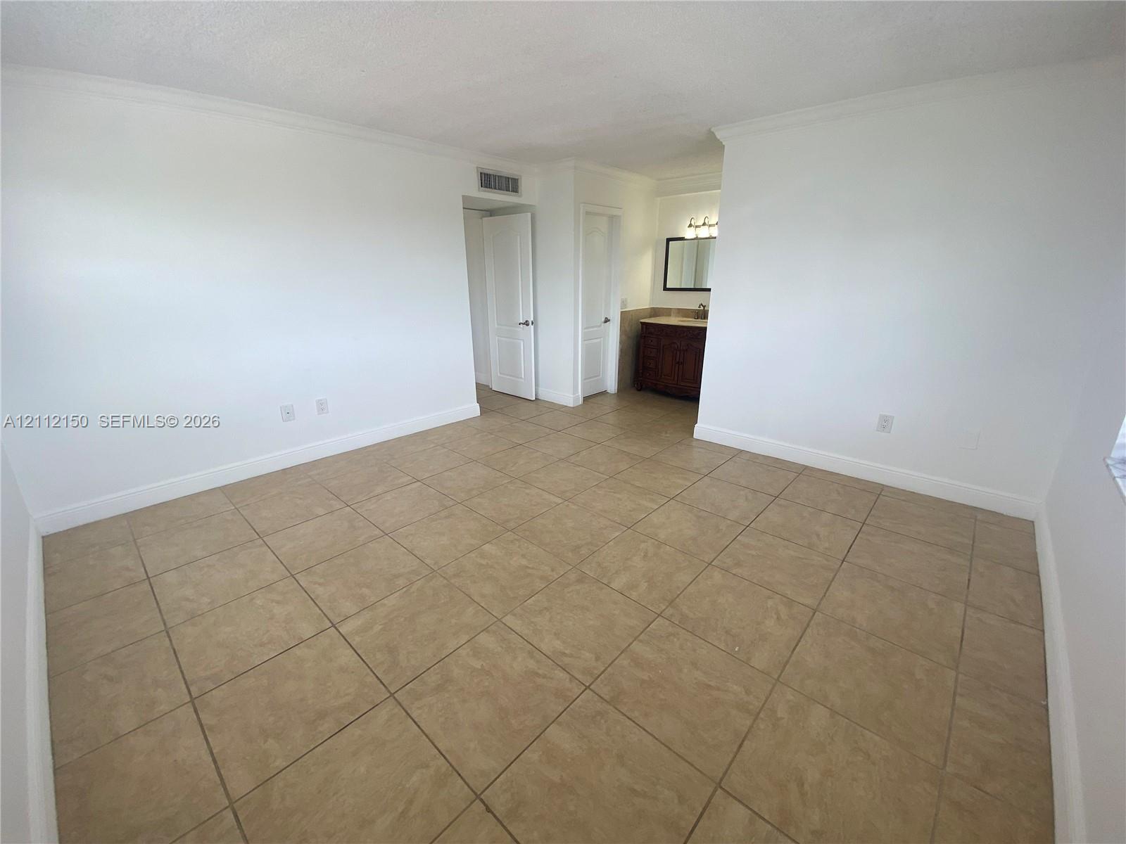Neutral-toned ceramic tile flooring, dual multi-pane windows with horizontal blinds, and smooth-finish white walls