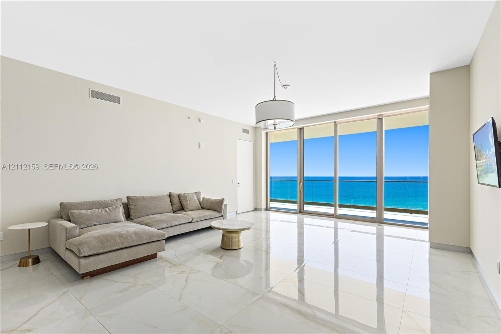 Polished stone flooring, floor-to-ceiling glass sliding doors, private balcony, and pendant lighting Polished stone flooring, floor-to-ceiling glass sliding doors, private balcony, and pendant lighting